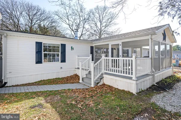 a view of a dining room with furniture wooden floor and a potted plant