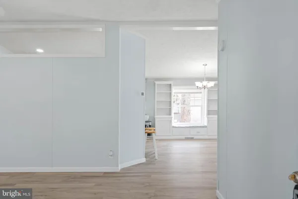 an empty room with windows and a fireplace