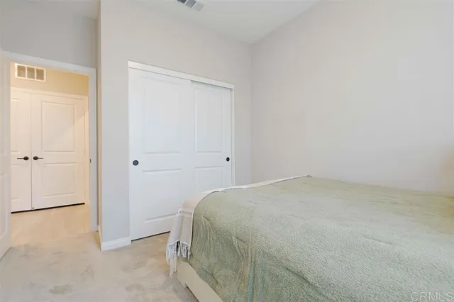 a room with a bed and cabinets