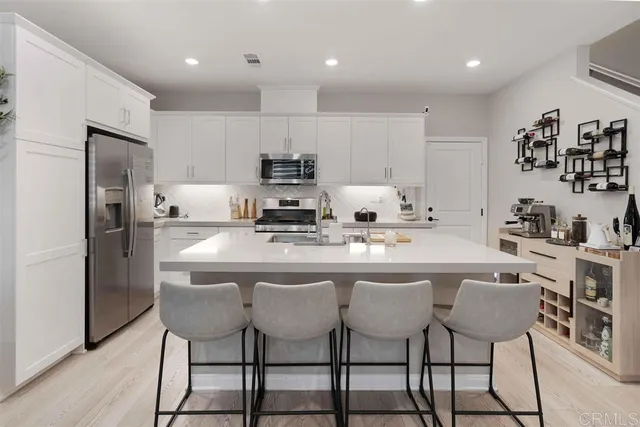 a kitchen with kitchen island cabinets and refrigerator