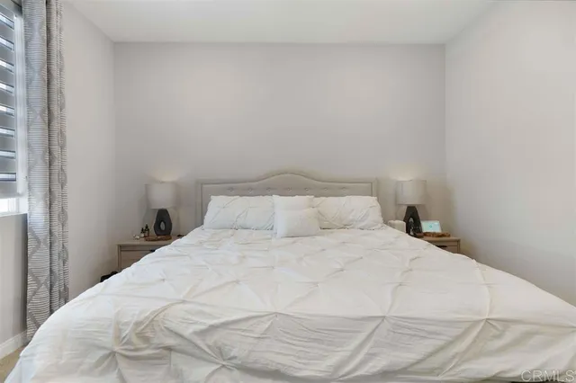 a large white bed in a small room