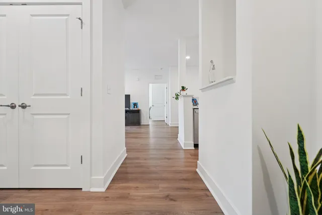 an empty room with wooden floor and mirror