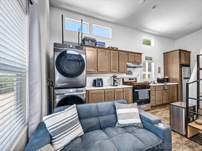 14291 Rios Canyon Road, Unit 3 El Cajon, CA 92021 - Photo 9 of 16 a living room with furniture and a kitchen view