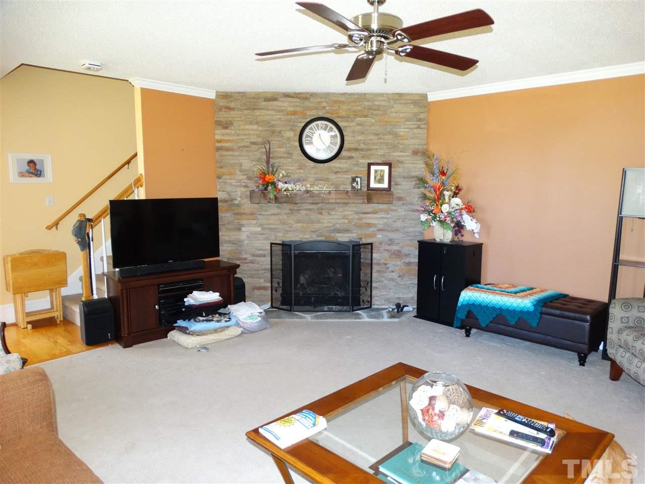 4916 Topstone Road Raleigh, NC 27603 - Photo 11 of 25 a living room with furniture and a flat screen tv