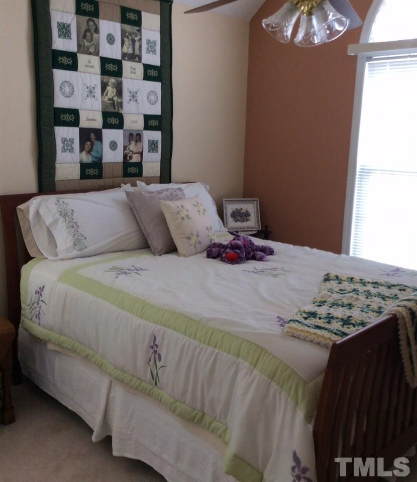 4916 Topstone Road Raleigh, NC 27603 - Photo 13 of 25 a bedroom with a bed and a window