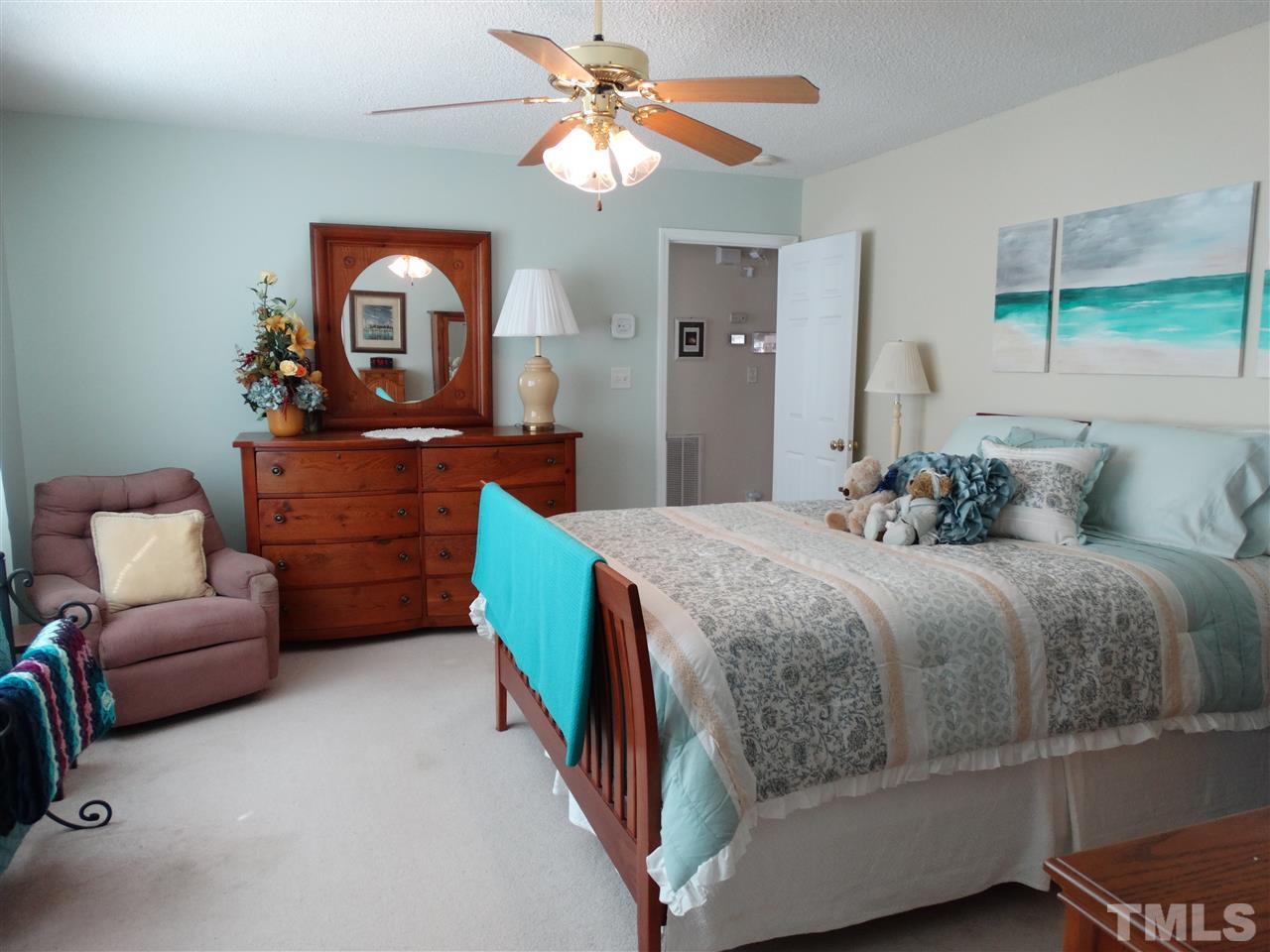 4916 Topstone Road Raleigh, NC 27603 - Photo 14 of 25 a bedroom with a bed and a couch