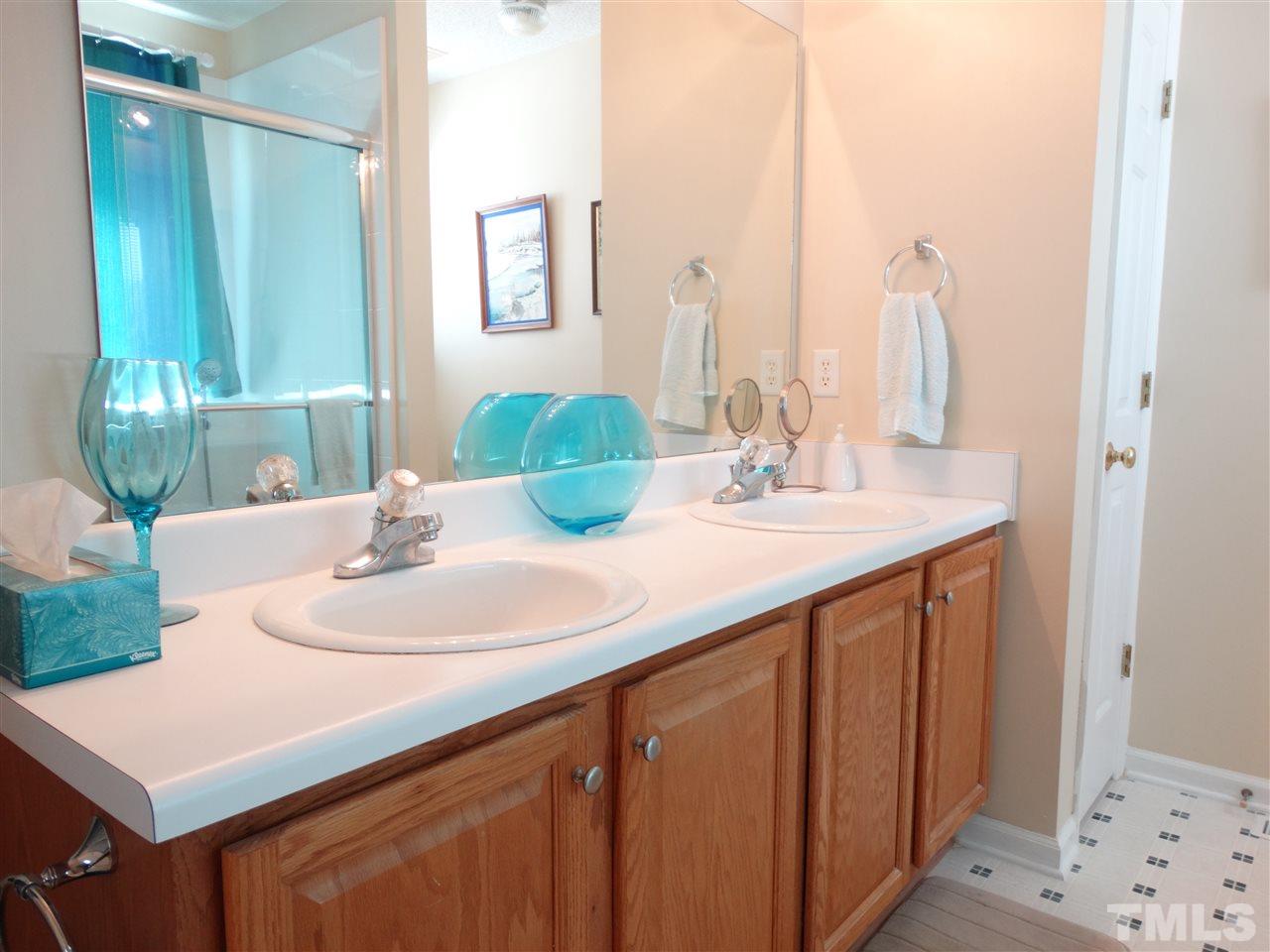 4916 Topstone Road Raleigh, NC 27603 - Photo 16 of 25 a bathroom with a sink vanity and a mirror