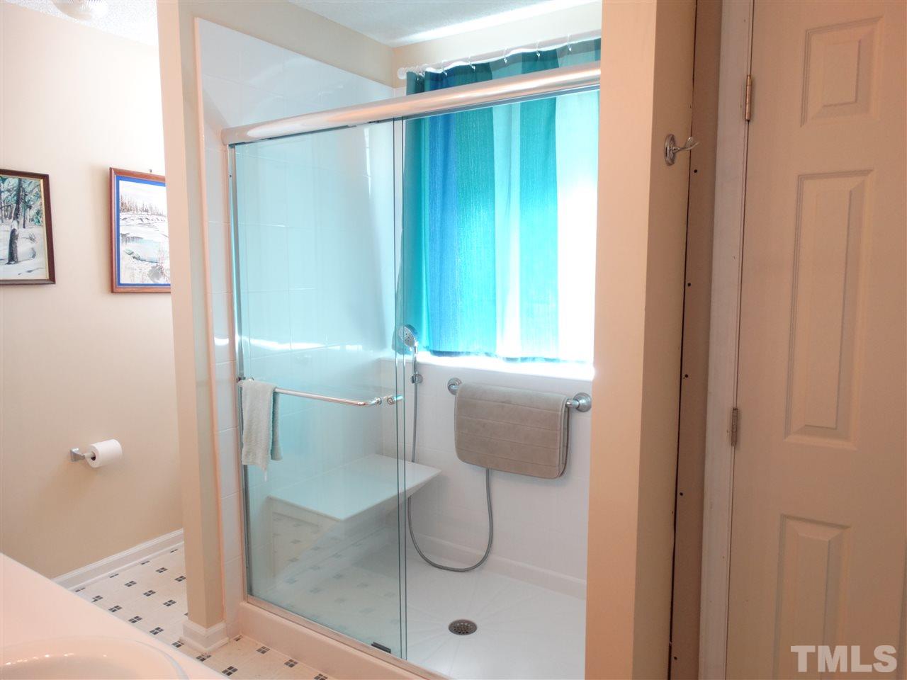 4916 Topstone Road Raleigh, NC 27603 - Photo 17 of 25 a bathroom with a glass shower door