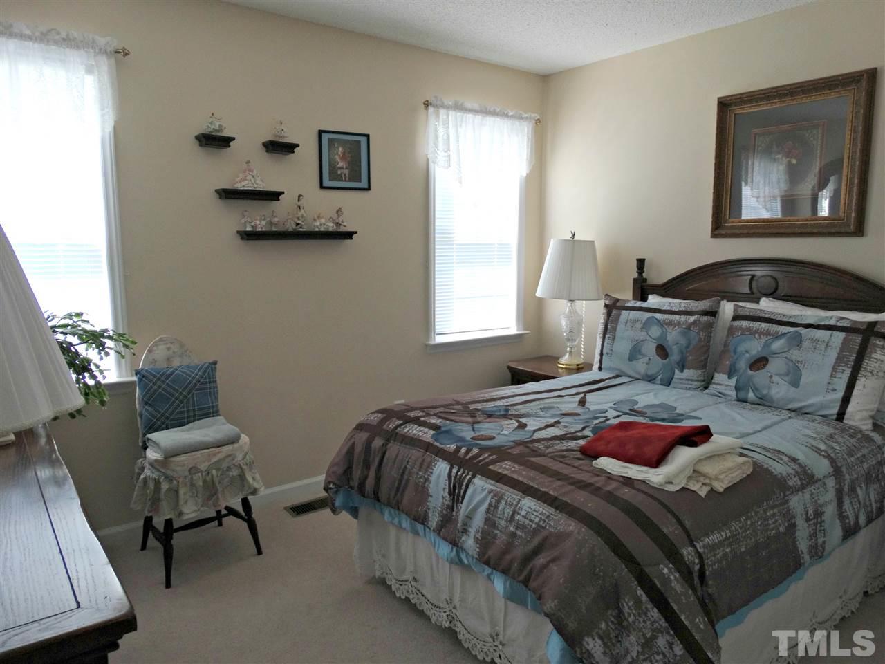 4916 Topstone Road Raleigh, NC 27603 - Photo 18 of 25 a bedroom with a bed and chair