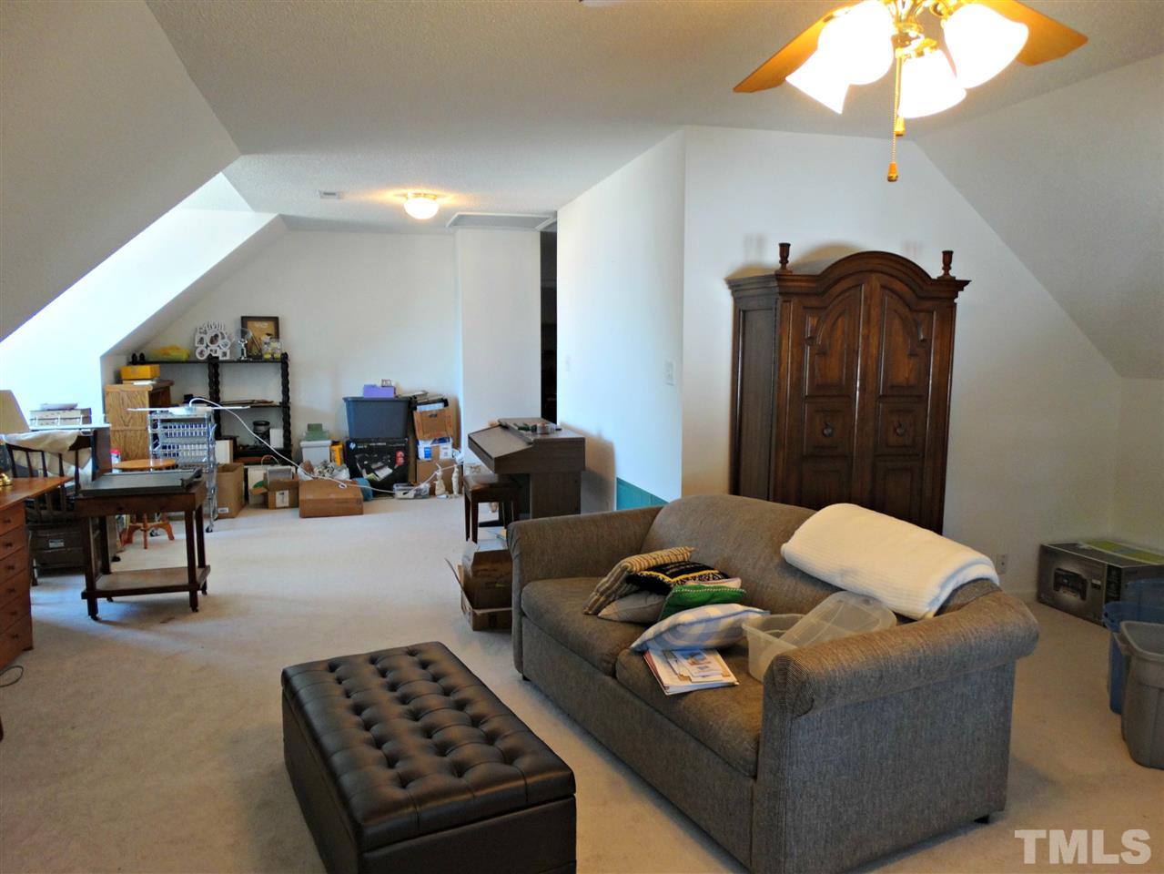 4916 Topstone Road Raleigh, NC 27603 - Photo 21 of 25 a living room with furniture and a mirror