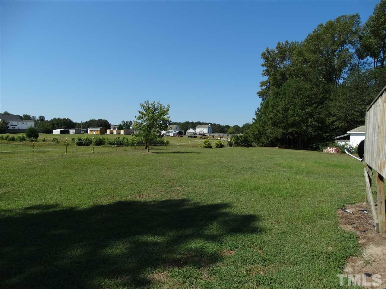4916 Topstone Road Raleigh, NC 27603 - Photo 25 of 25 a view of a grassy field with trees