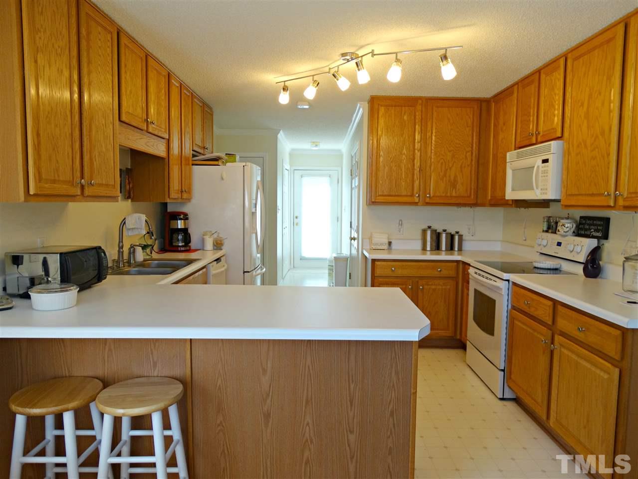 4916 Topstone Road Raleigh, NC 27603 - Photo 6 of 25 a kitchen with cabinets a sink and appliances