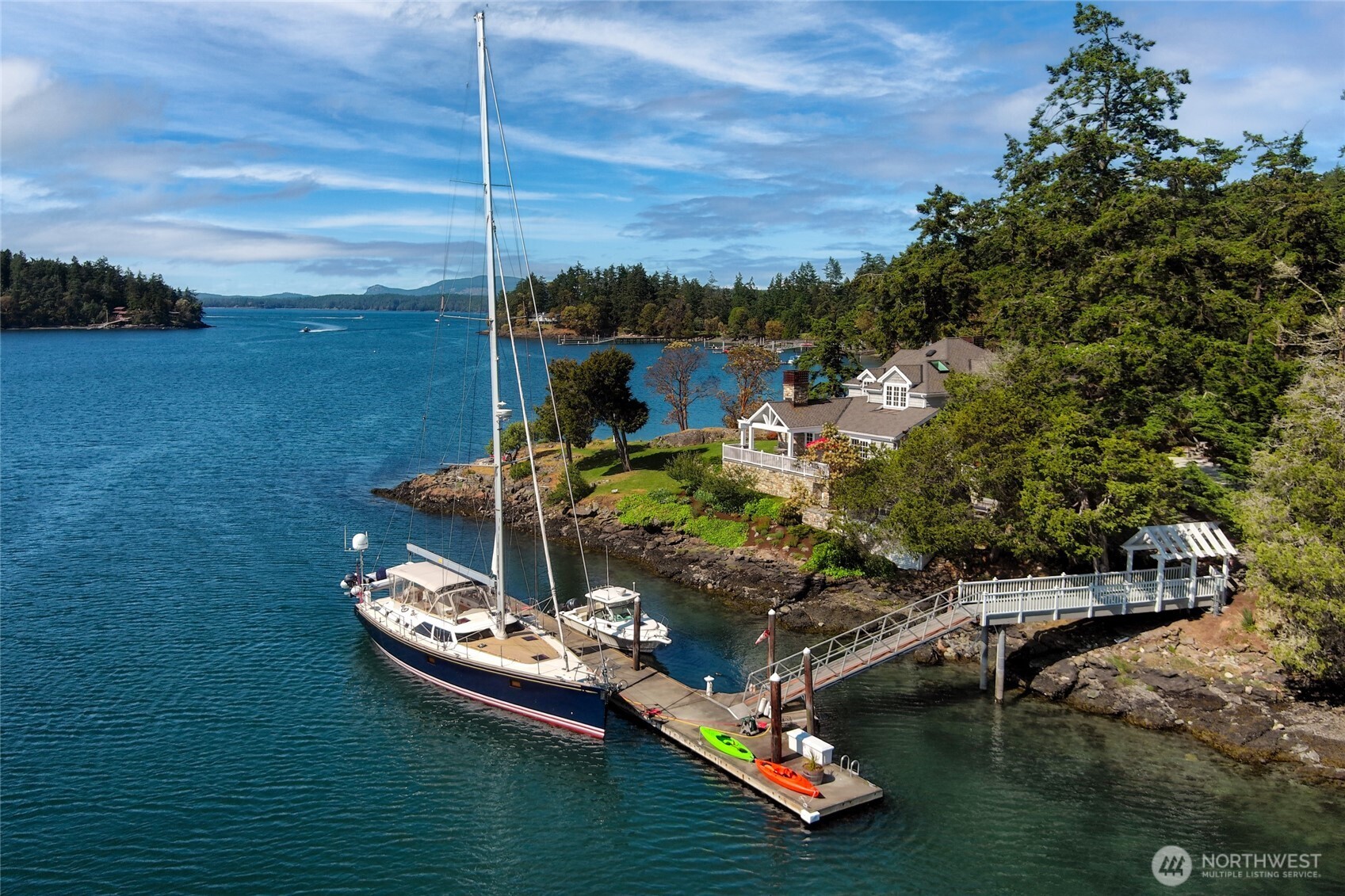 95 Laurel Point Lane Friday Harbor, WA 98250 - Photo 3 of 40 a ocean view with boat and palm trees
