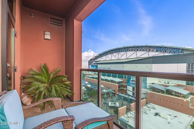 a living room with furniture a rug potted plant and a window