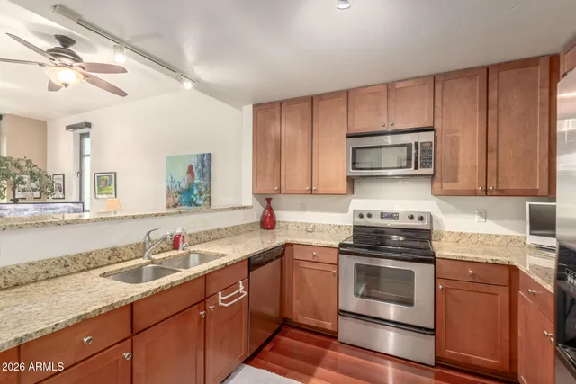 a kitchen with a sink appliances and cabinets