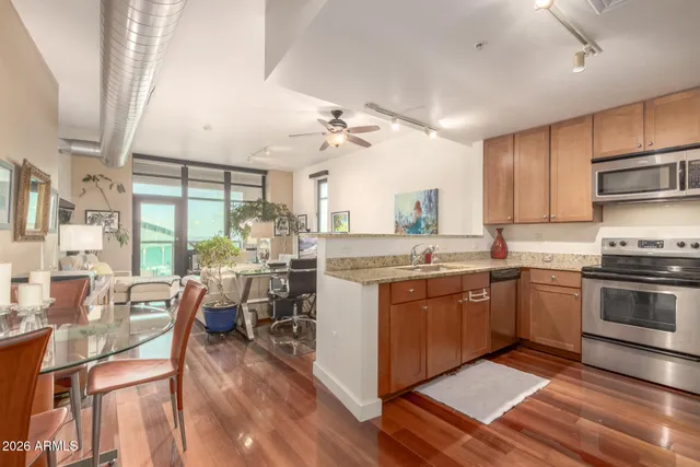 a spacious bathroom with a granite countertop sink and a large mirror