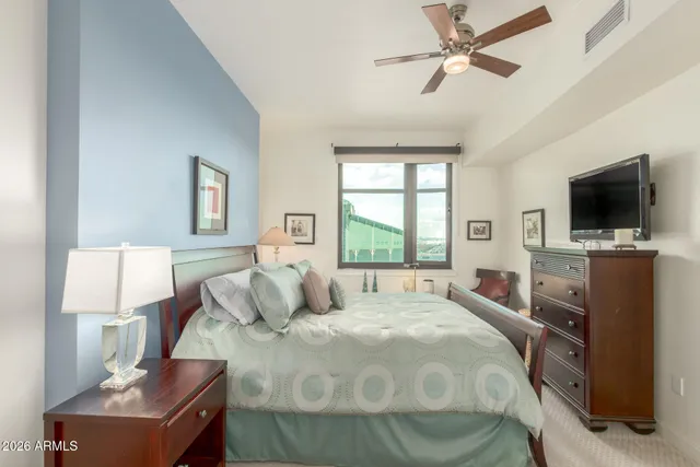 a bedroom with a bed and a television