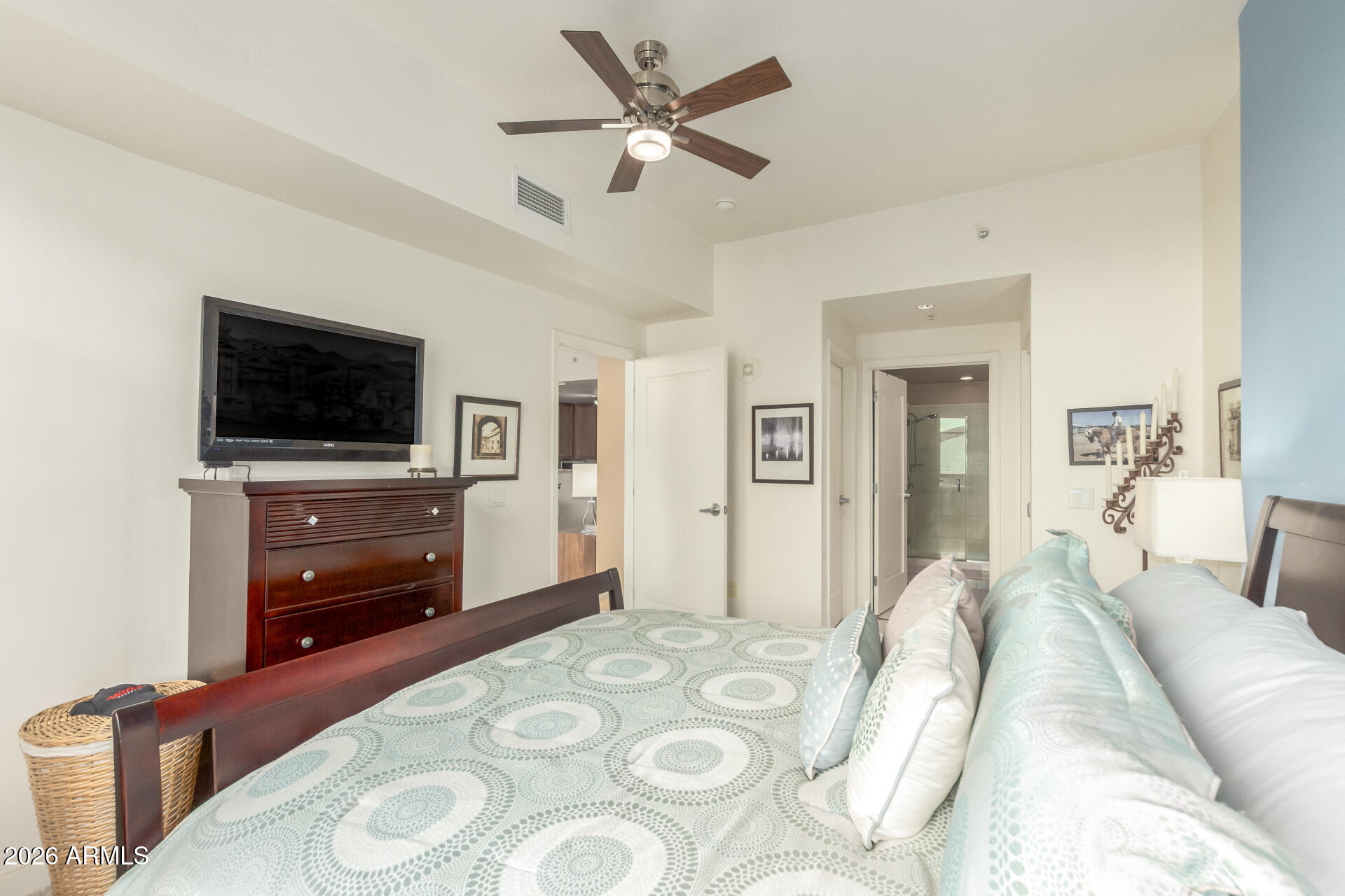 310 South 4th Street, Unit 1109 Phoenix, AZ 85004 - Photo 18 of 36 a bedroom with a bed and a flat screen tv