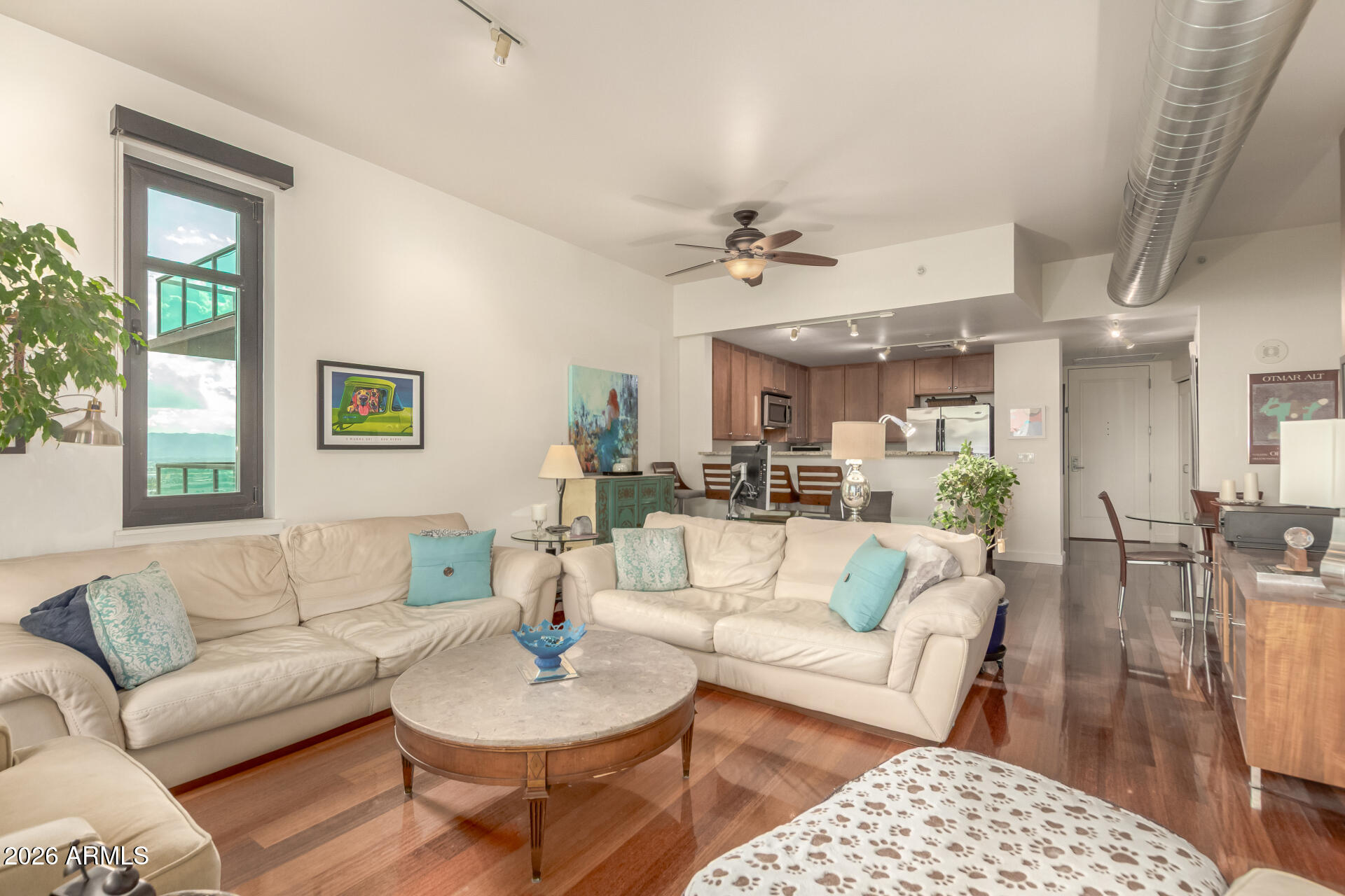 310 South 4th Street, Unit 1109 Phoenix, AZ 85004 - Photo 2 of 36 a living room with furniture a rug potted plant and a window