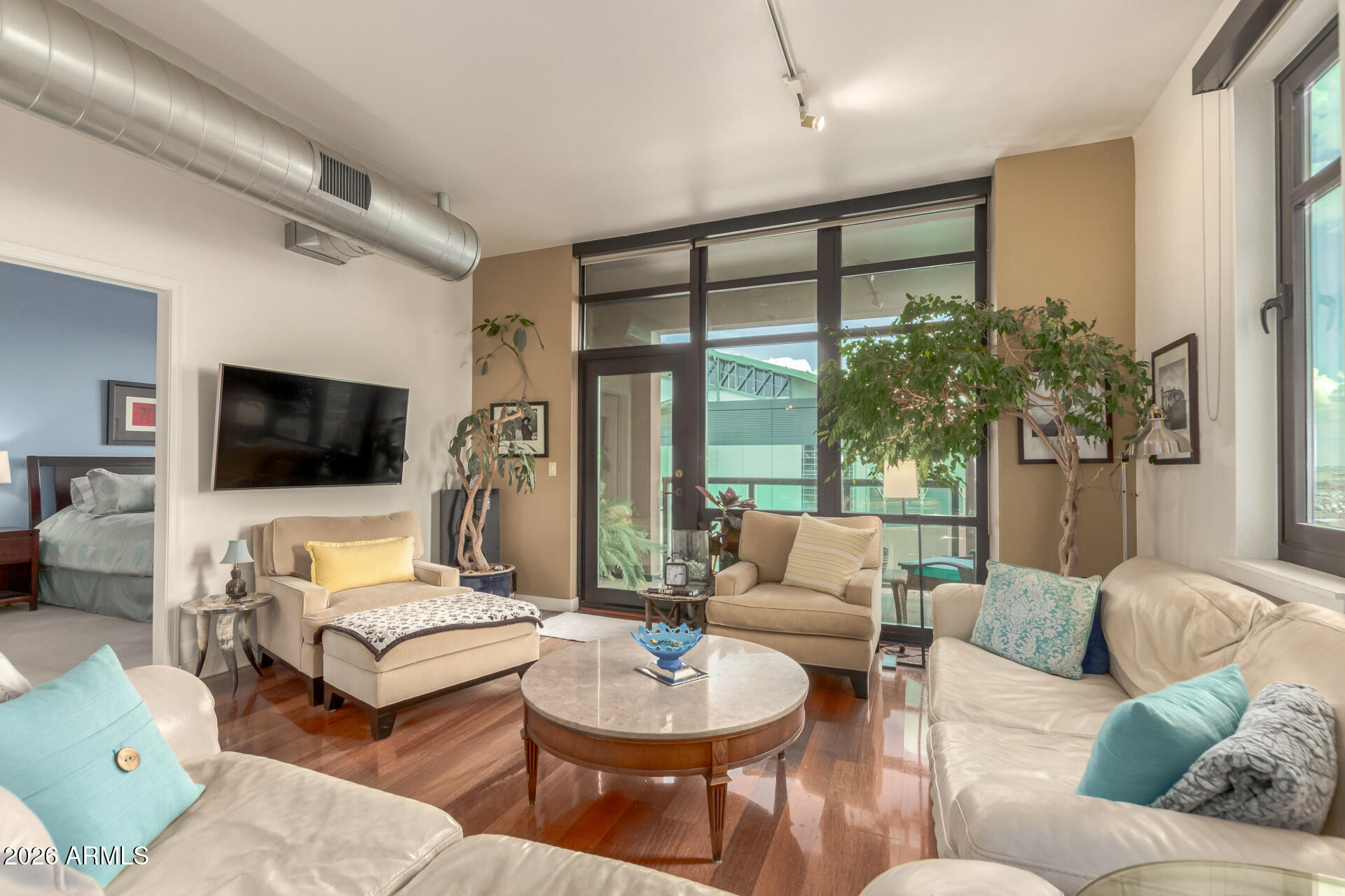 310 South 4th Street, Unit 1109 Phoenix, AZ 85004 - Photo 5 of 36 a living room with furniture and a flat screen tv
