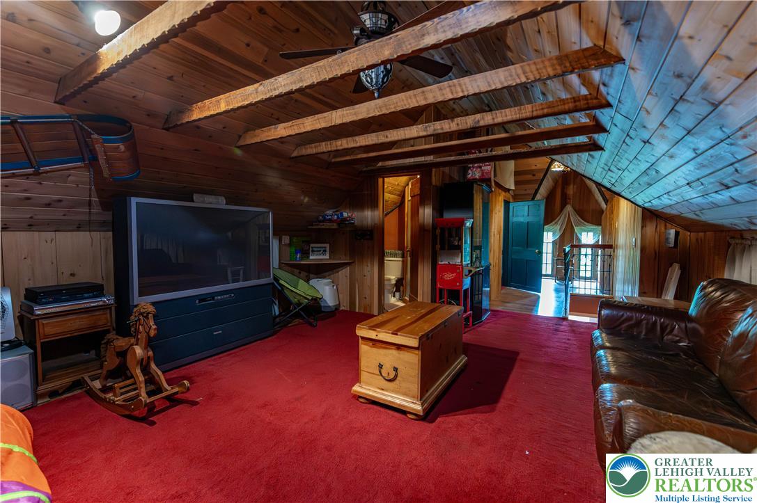 2485 Hieter Road Quakertown, PA 18951 - Photo 50 of 97 A rustic attic retreat offers a wood-paneled ceiling with exposed beams, ideal for a cozy hideaway.
