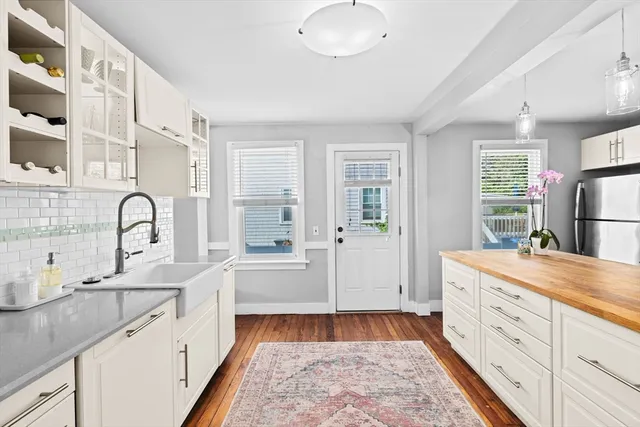 a spacious bathroom with a granite countertop sink and a mirror