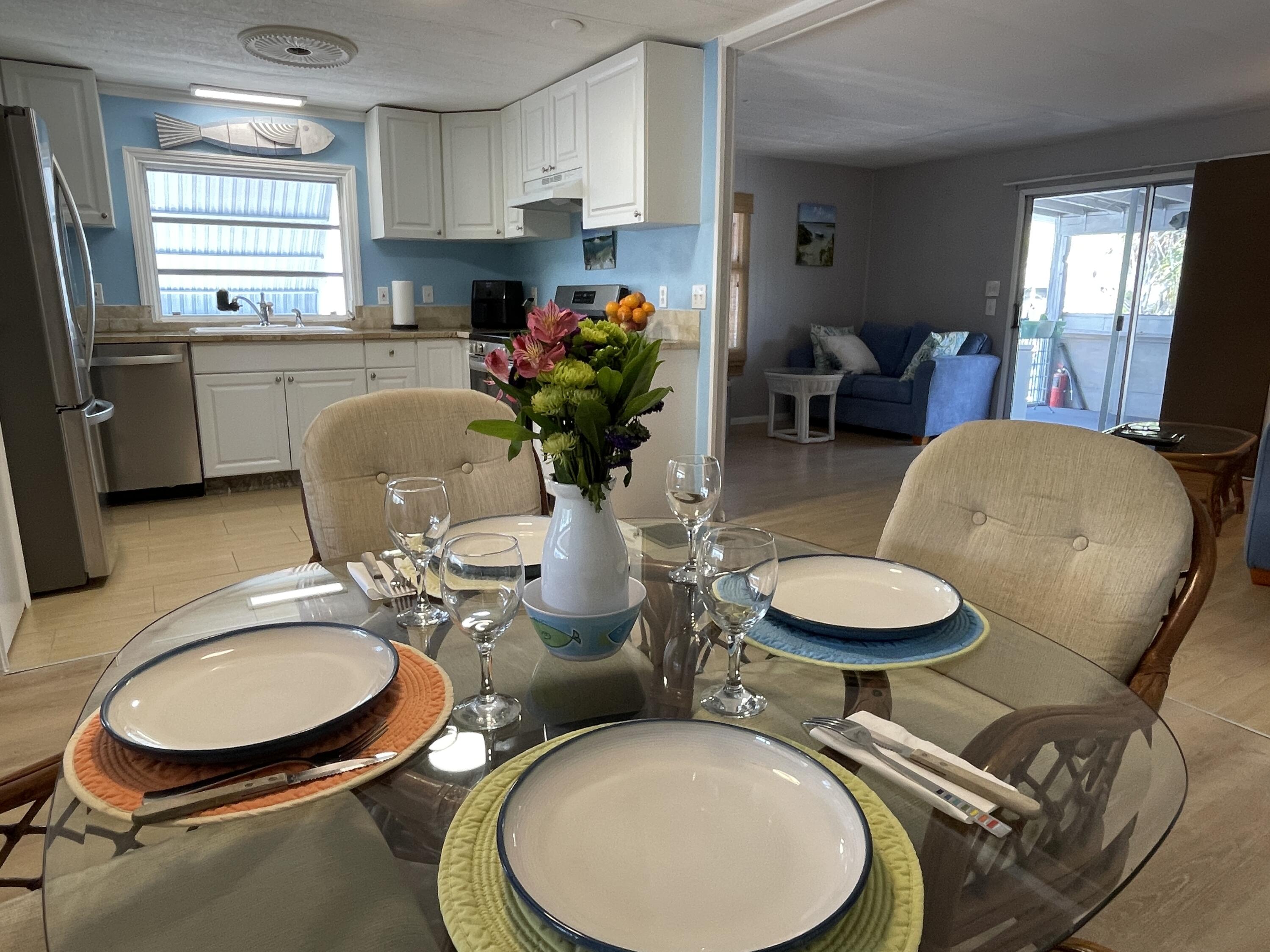 27853 Coral Shores Road Summerland Key, FL 33042 - Photo 12 of 47 a dining room with furniture a potted plant and wooden floor