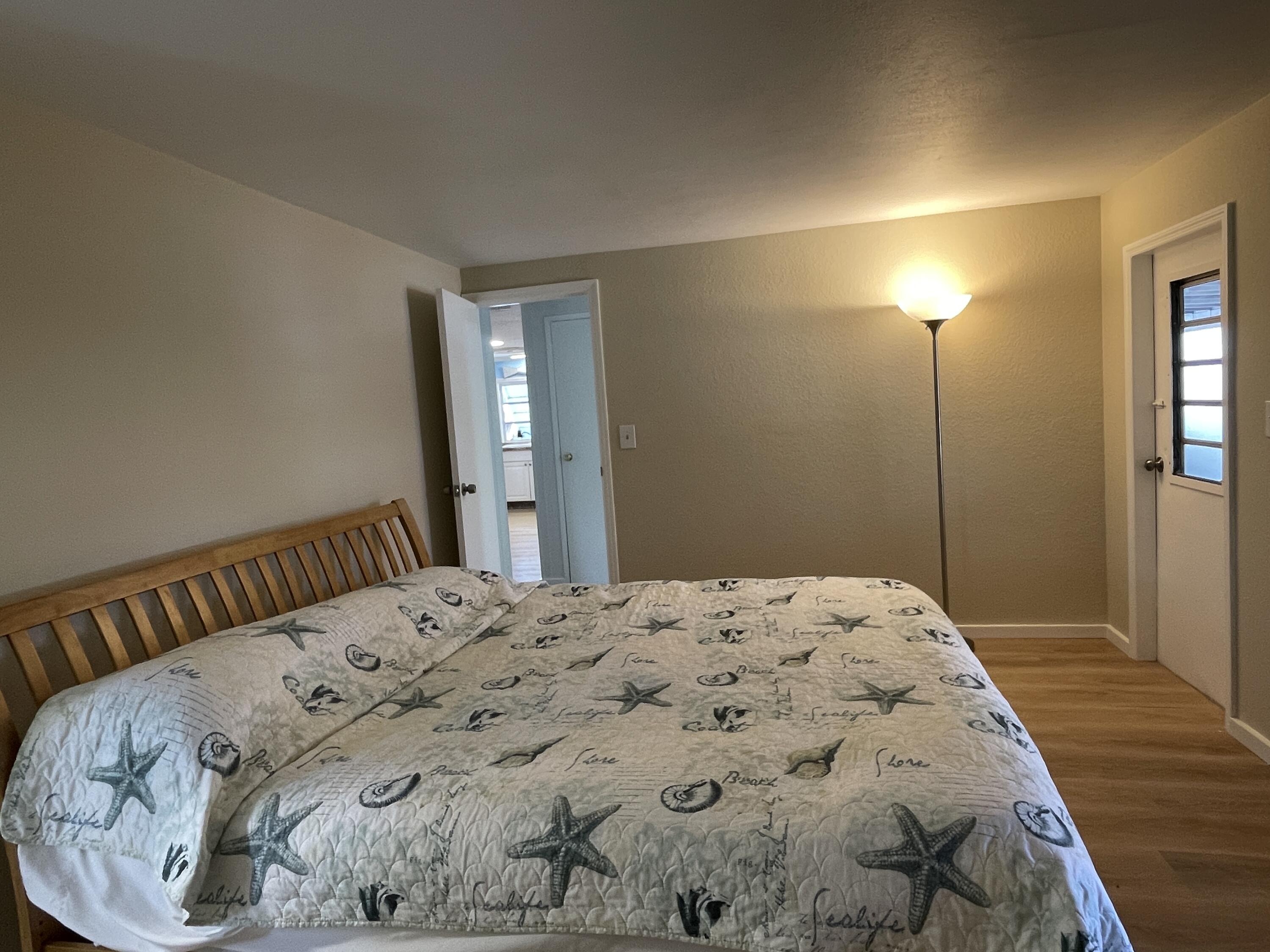 27853 Coral Shores Road Summerland Key, FL 33042 - Photo 21 of 47 a bedroom with a bed and wooden floor