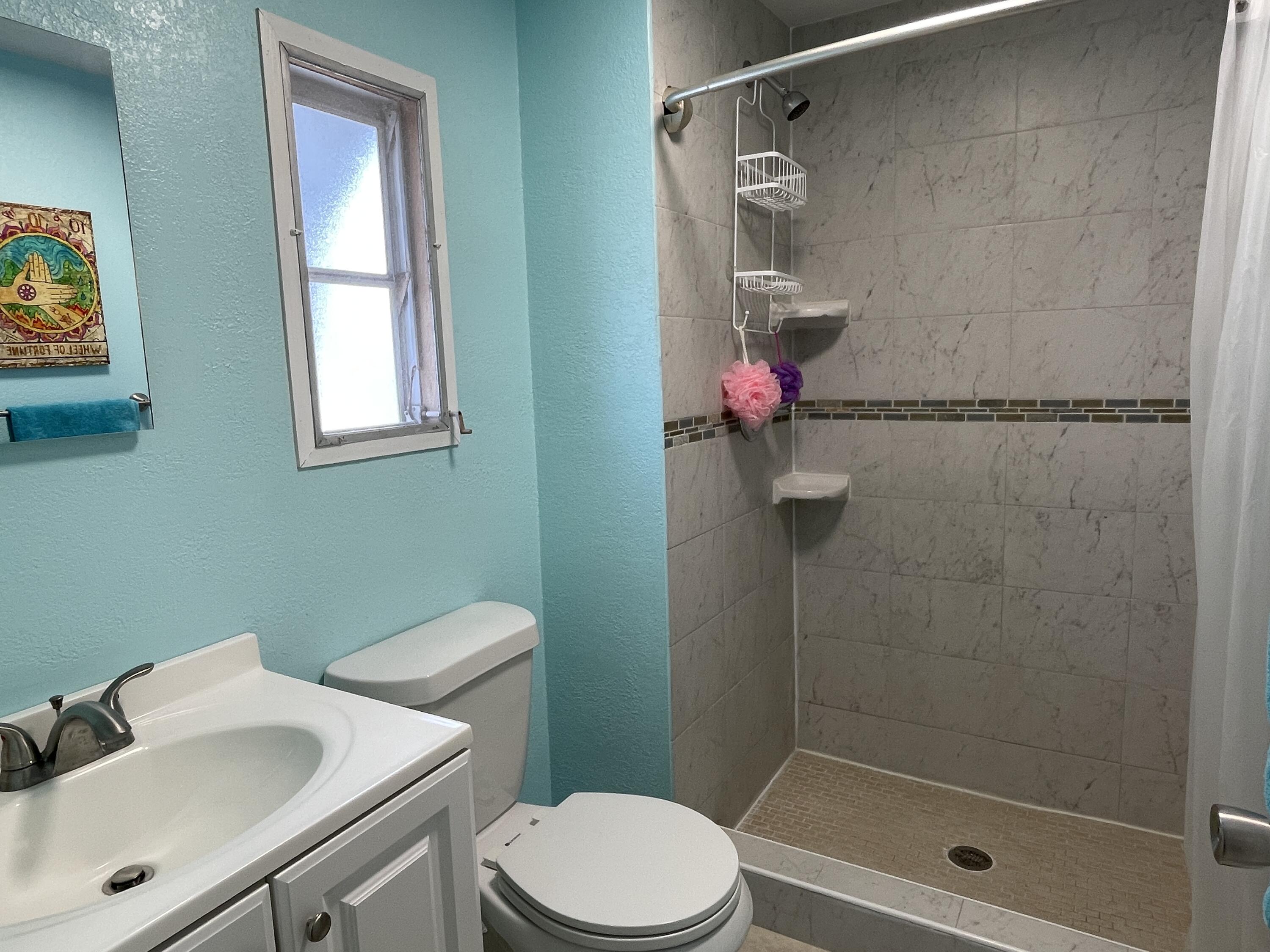 27853 Coral Shores Road Summerland Key, FL 33042 - Photo 23 of 47 a bathroom with a shower a toilet and a sink