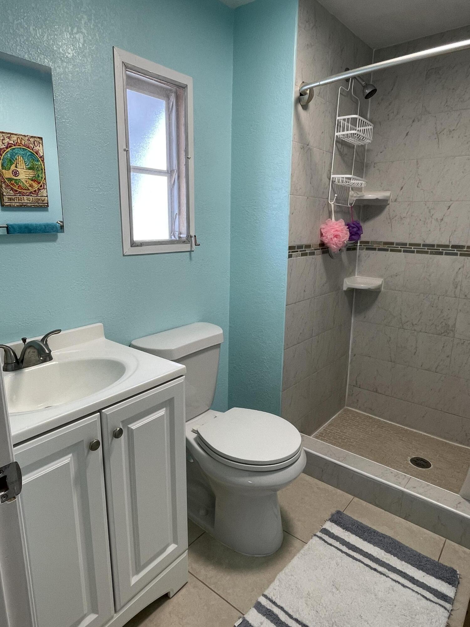 27853 Coral Shores Road Summerland Key, FL 33042 - Photo 24 of 47 a bathroom with a sink toilet and shower