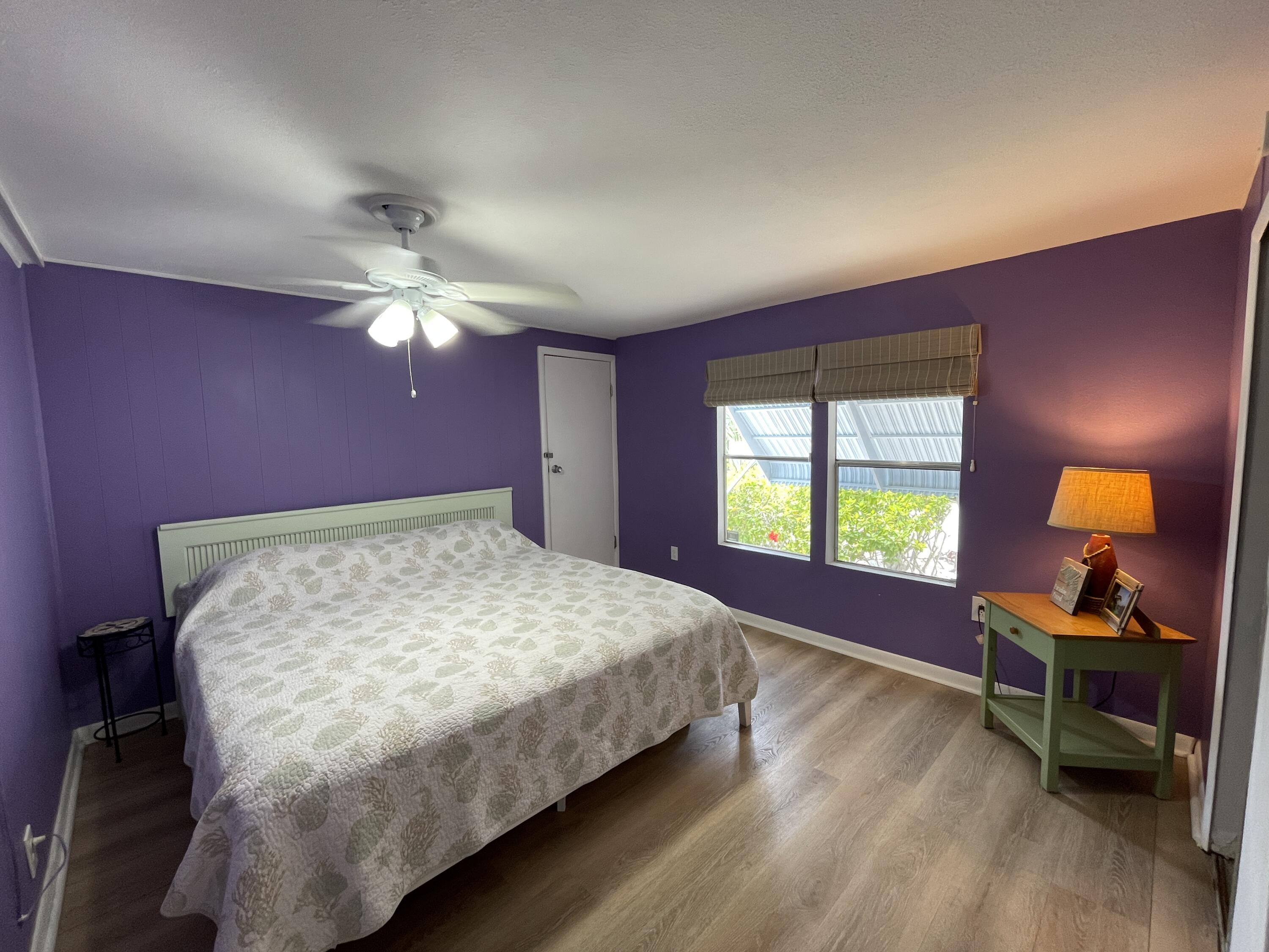 27853 Coral Shores Road Summerland Key, FL 33042 - Photo 25 of 47 a bedroom with a bed and a dresser next to a window