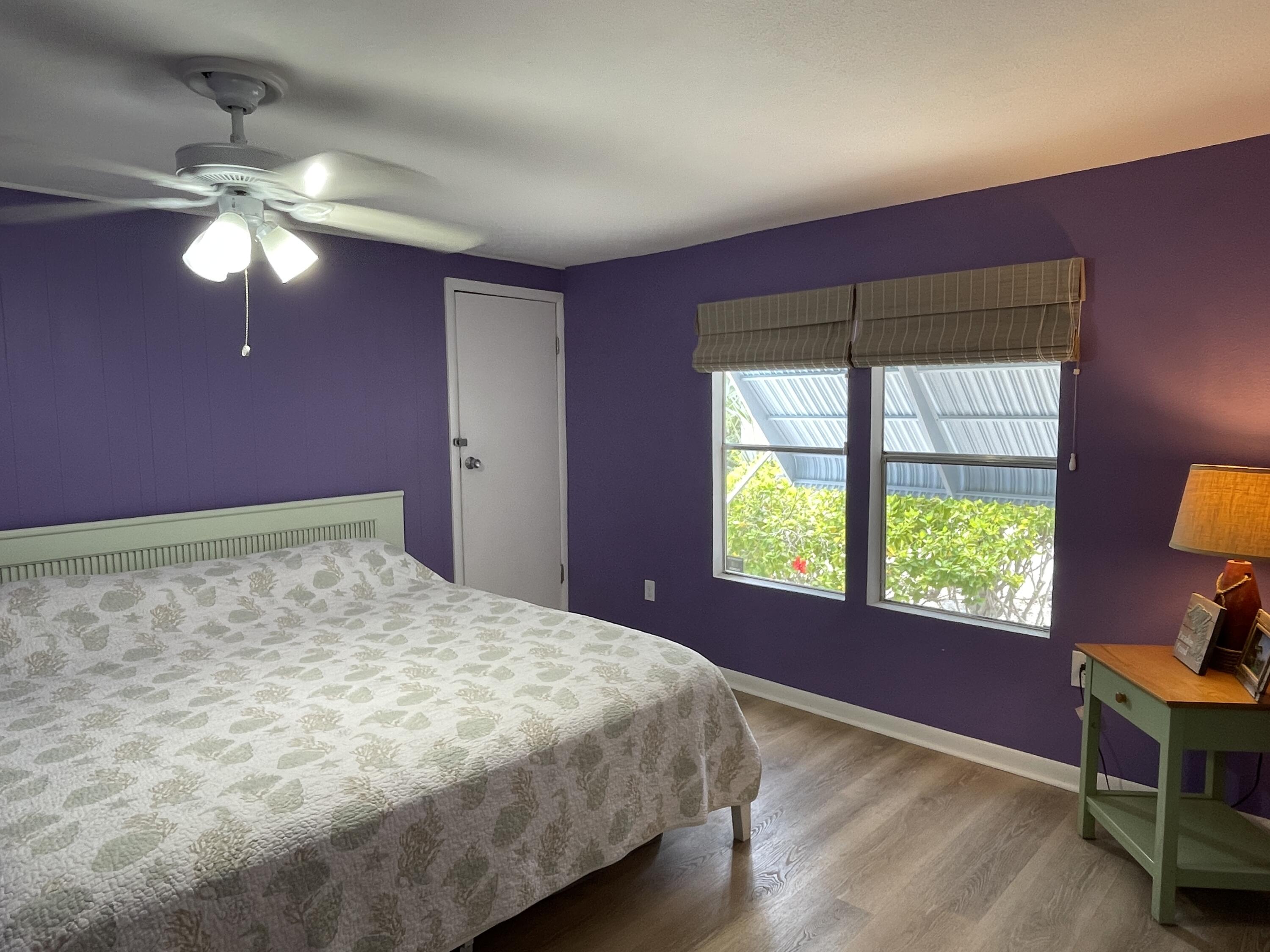 27853 Coral Shores Road Summerland Key, FL 33042 - Photo 26 of 47 a bedroom with a bed and a chandelier