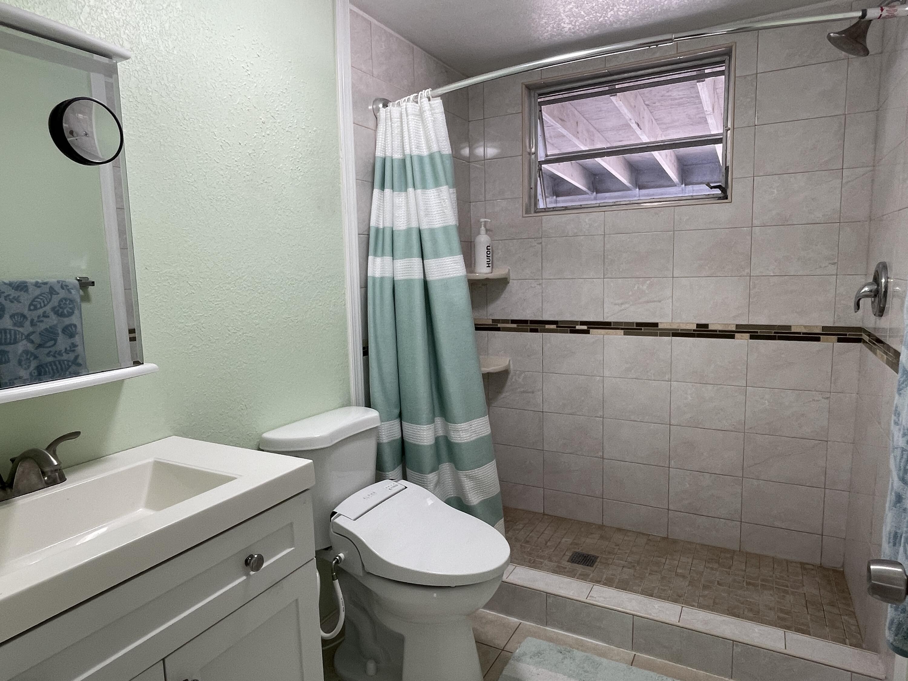 27853 Coral Shores Road Summerland Key, FL 33042 - Photo 28 of 47 a bathroom with a sink toilet and shower