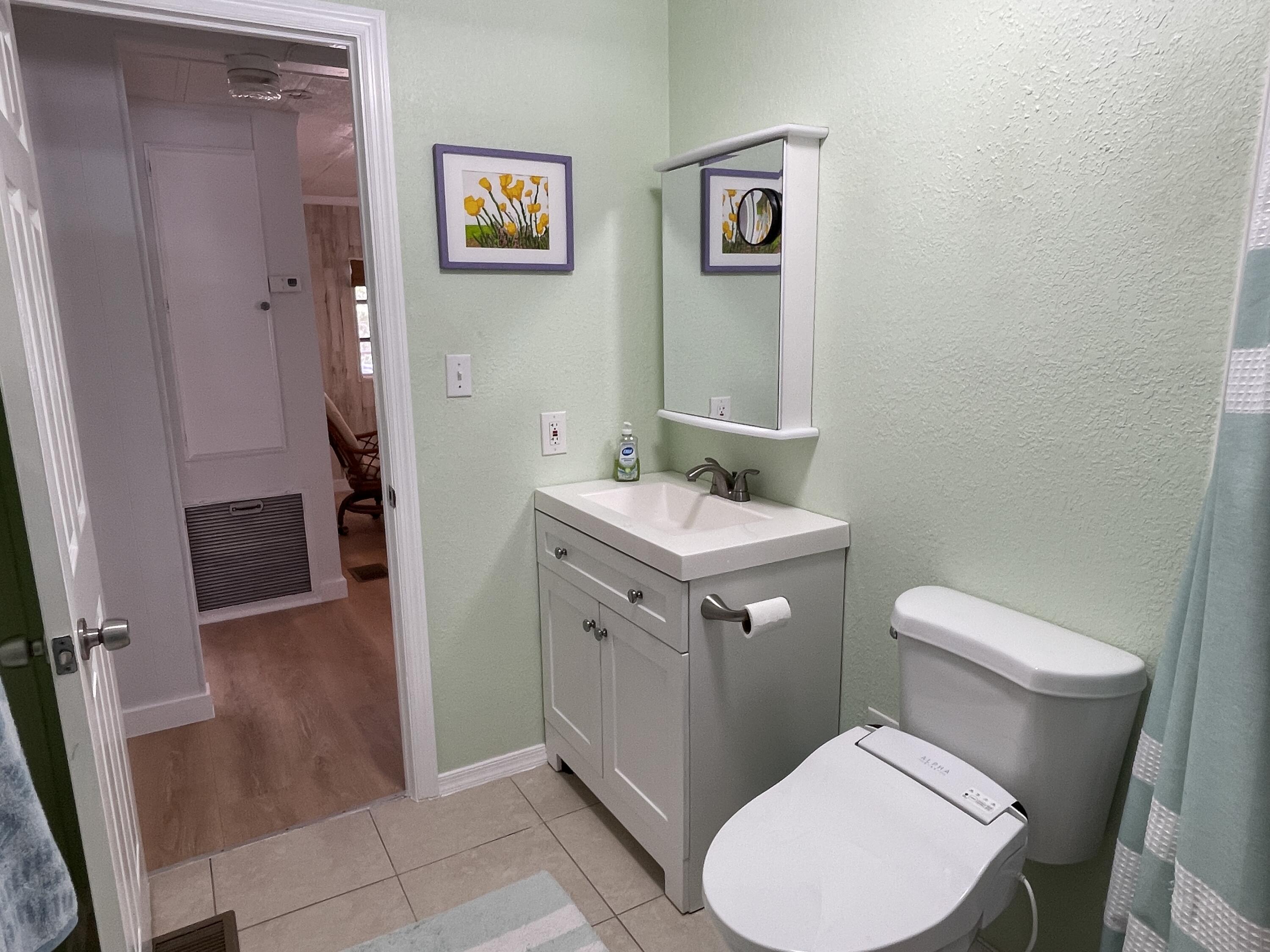 27853 Coral Shores Road Summerland Key, FL 33042 - Photo 29 of 47 a bathroom with a toilet sink and mirror