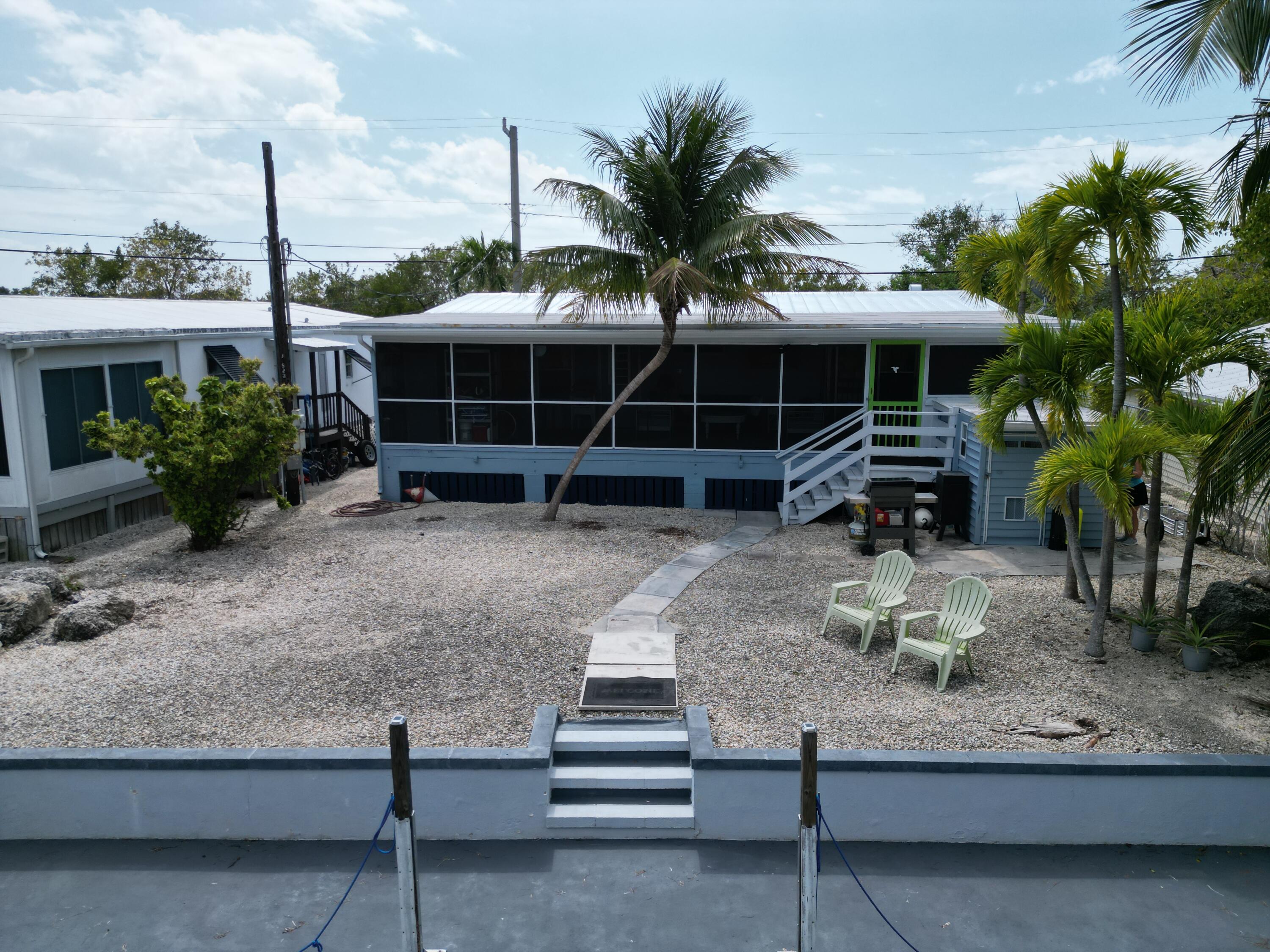 27853 Coral Shores Road Summerland Key, FL 33042 - Photo 3 of 47 a view of a house with a yard and sitting area