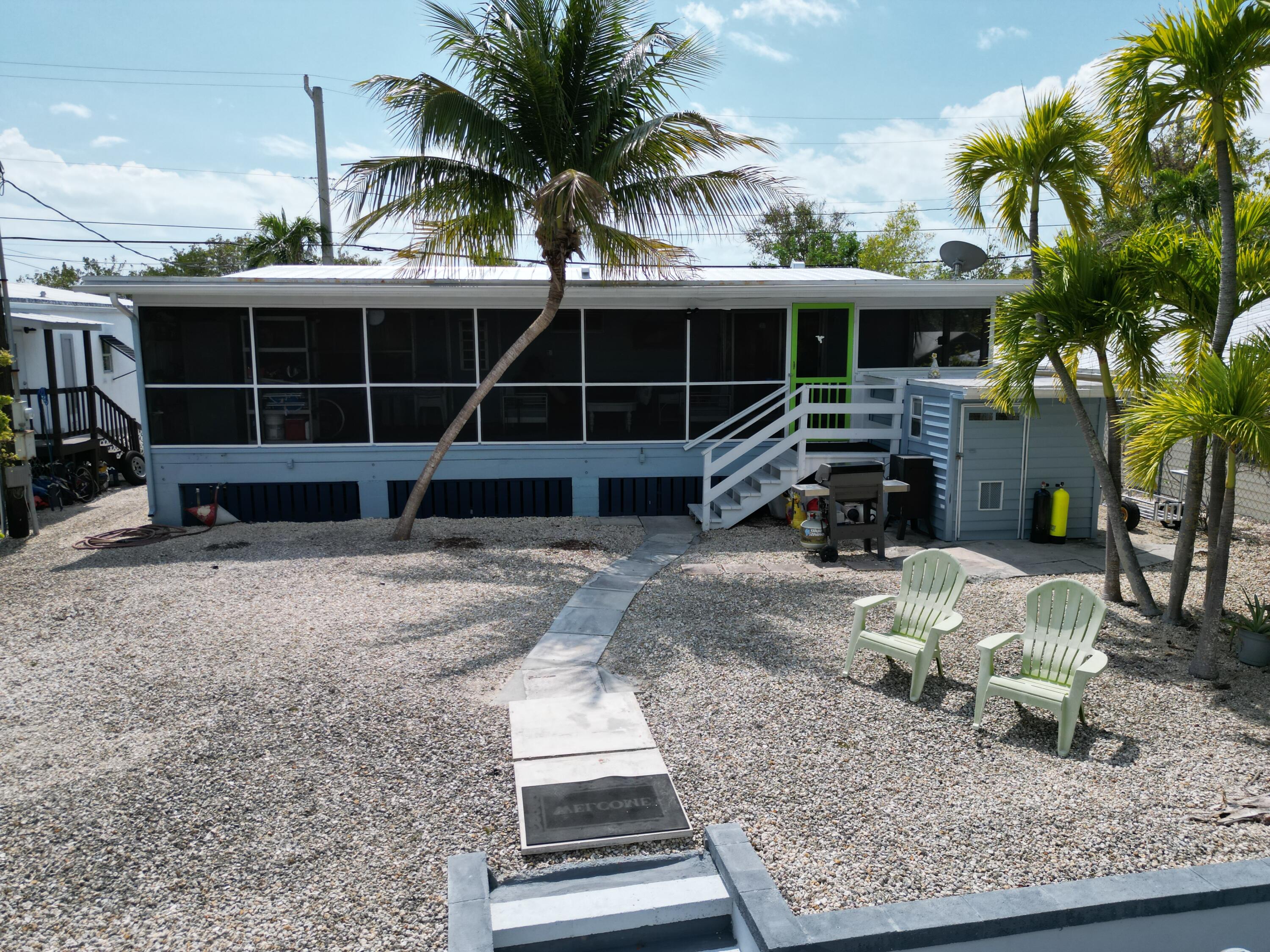 27853 Coral Shores Road Summerland Key, FL 33042 - Photo 4 of 47 a front view of a house with garden