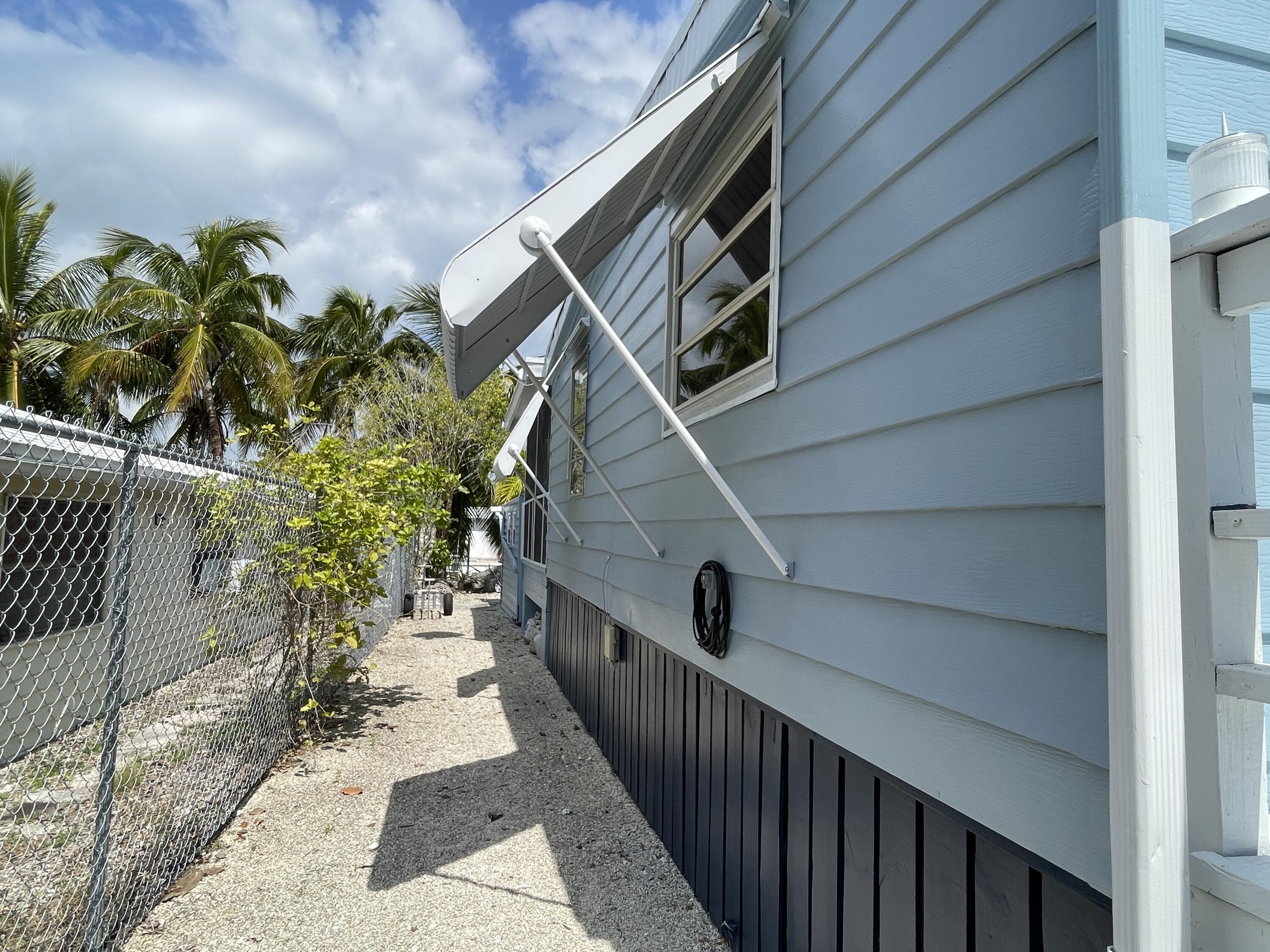 27853 Coral Shores Road Summerland Key, FL 33042 - Photo 43 of 47 a balcony with wooden floor and potted plants