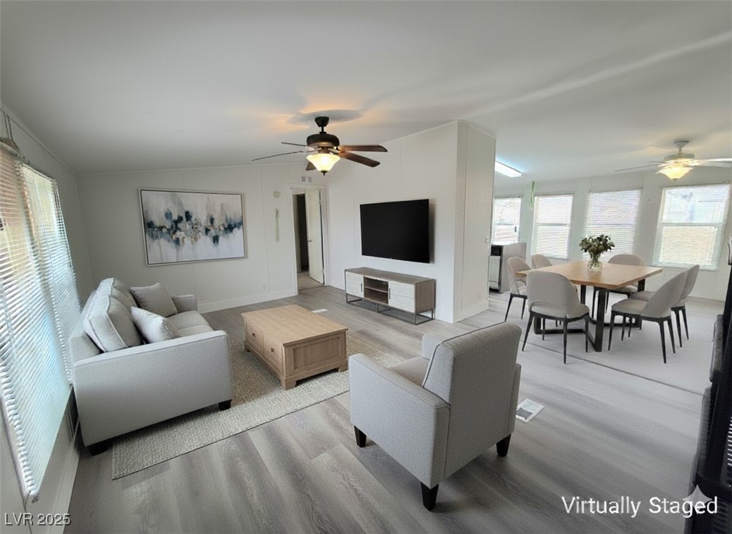 3290 Medicine Man Road Pahrump, NV 89048 - Photo 5 of 27 Living area with healthy amount of natural light, a ceiling fan, wood finished floors, and lofted ceiling