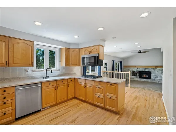 a kitchen with stainless steel appliances granite countertop a sink counter space and cabinets