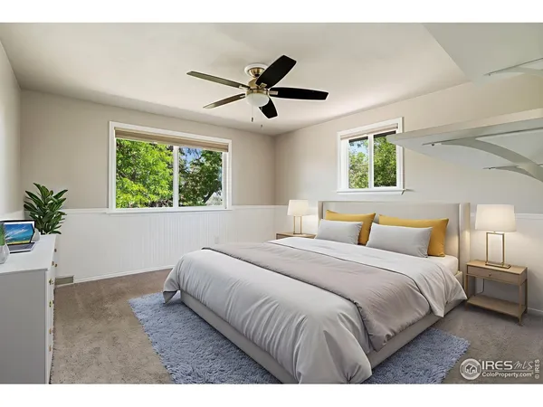 a bedroom with a large bed and a window