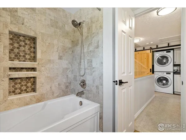 a view of a hallway with washer and dryer
