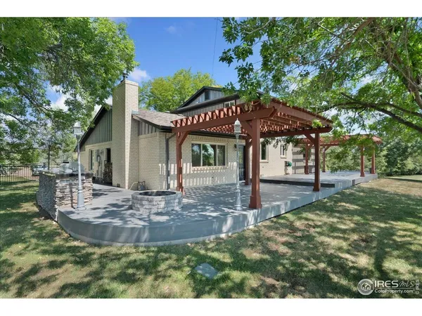 a backyard of a house with table and chairs