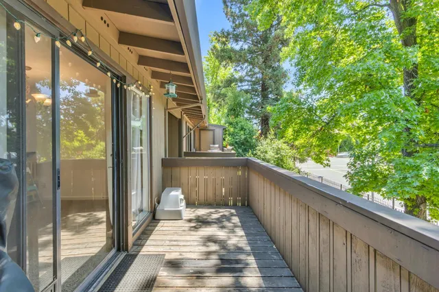 a view of a balcony with a tree