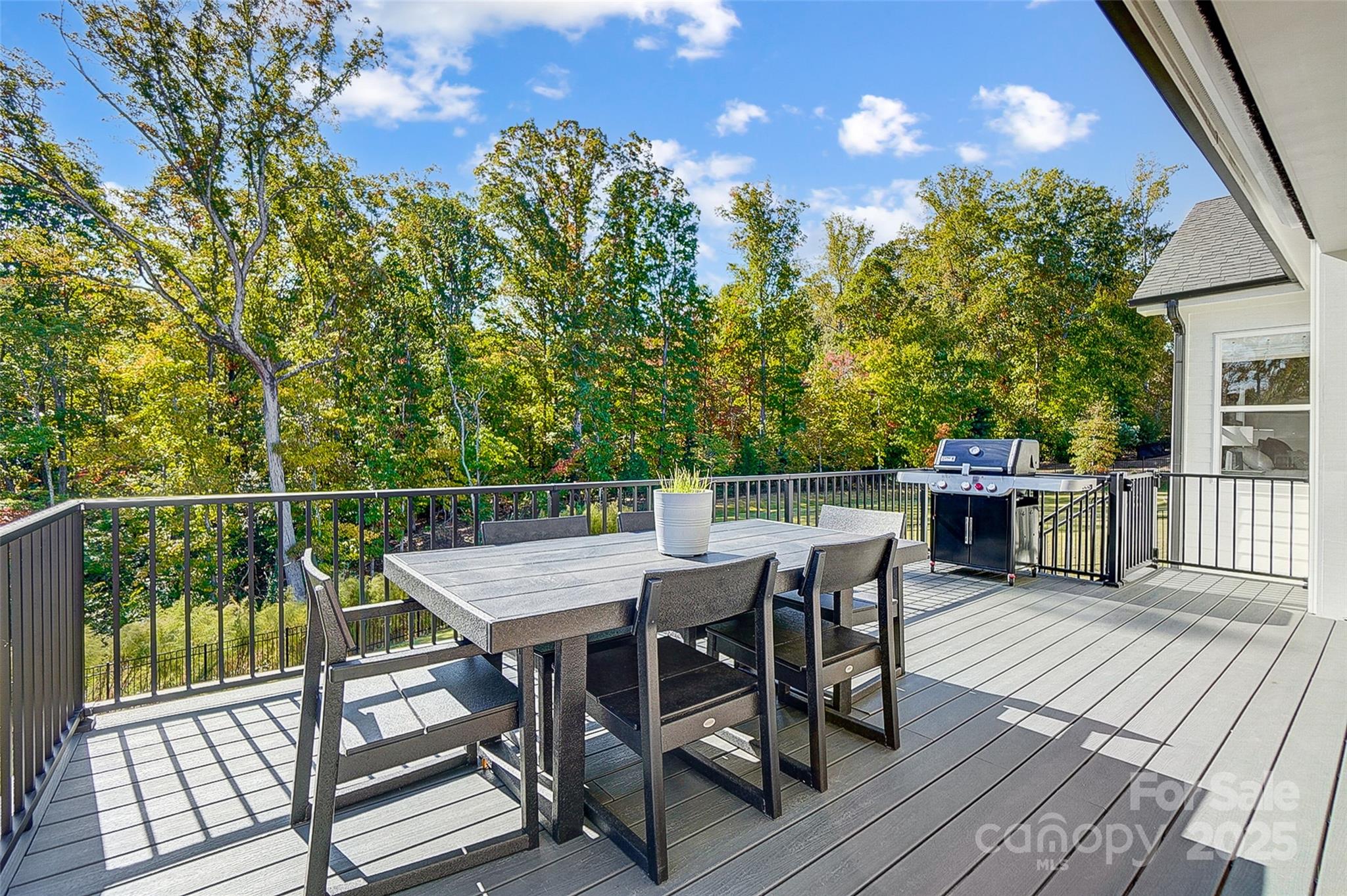 4116 Spring Cove Way Belmont, NC 28012 - Photo 32 of 44 a view of a roof deck with table and chairs with wooden floor and fence