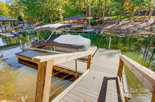 a view of a chairs and table in patio with a lake view