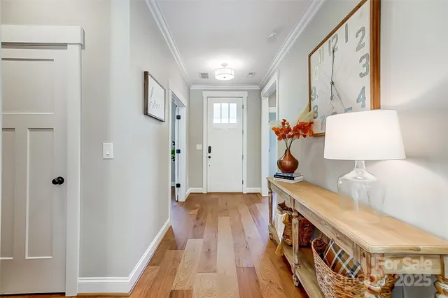 a view of hallway with wooden floor
