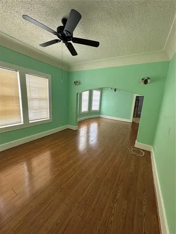a view of room with window and wooden floor