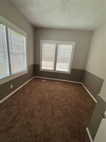 an empty room with a empty space and windows