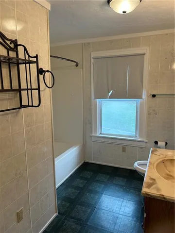 a bathroom with a bathtub and shower