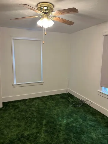 a view of a small space with a chandelier fan and a chandelier fan
